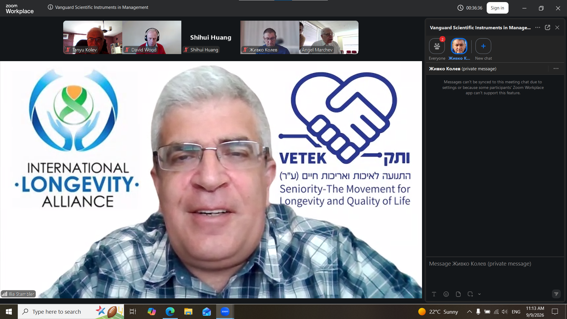 Ilya Stambler speaking online at VSIM 2026, with International Longevity Alliance branding behind him and conference participants visible above.